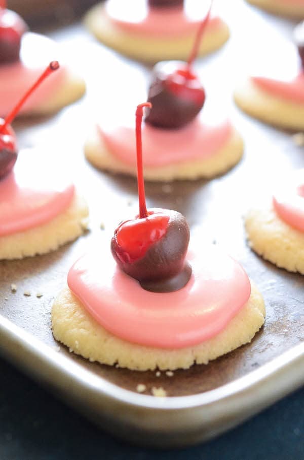 Cherry Cordial Cookies: these intricate looking cookies are surprisingly easy to make. You start with a soft shortbread cookie base, spread them with a creamy cherry cordial icing and top them with a chocolate cherry. 