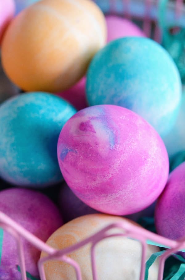 Pink watercolor easter eggs in a basket.