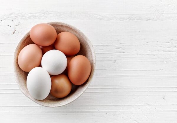 Brown and white eggs in a white bowl. 