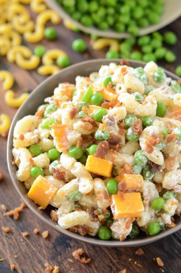 Bacon Ranch Pasta Salad in a bowl with bacon, cheese and peas. 