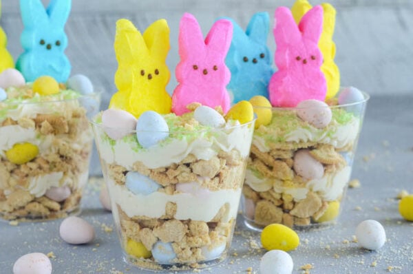 Oreo Easter Egg Cups are the perfect no bake Easter dessert with layers of crushed vanilla oreos, oreo cream filling buttercream, mini cadbury eggs and peeps!