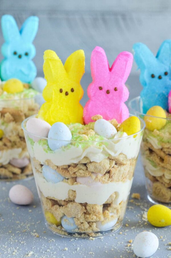 Oreo Easter Egg Cups are the perfect no bake Easter dessert with layers of crushed vanilla oreos, oreo cream filling buttercream, mini cadbury eggs and peeps!