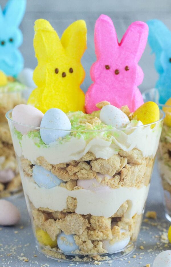 Oreo Easter Egg Cups are the perfect no bake Easter dessert with layers of crushed vanilla oreos, oreo cream filling buttercream, mini cadbury eggs and peeps!