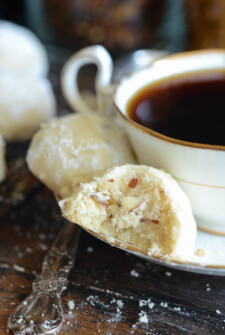 Two Almond Shortbread Cookies Next to a Cup of Black Tea