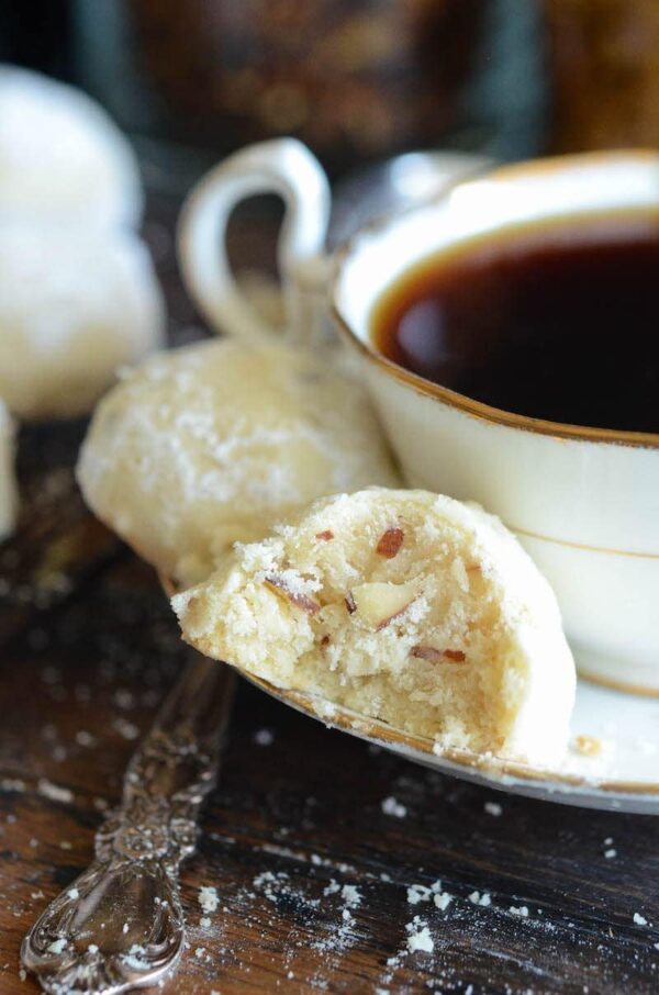 Two Almond Shortbread Cookies Next to a Cup of Black Tea