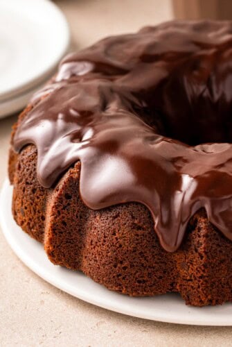 Thick chocolate ganache tops a chocolate milk bundt cake.