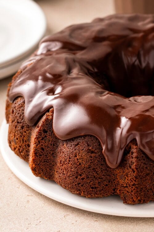 Thick chocolate ganache tops a chocolate milk bundt cake.