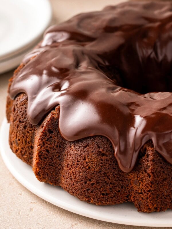 Thick chocolate ganache tops a chocolate milk bundt cake.