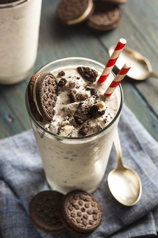 Cookies and Cream Milkshake in a glass with two straws.