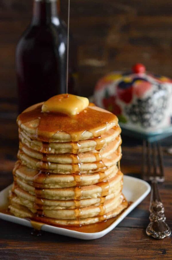 Large stack of keto pancakes with butter and sugar free syrup. 