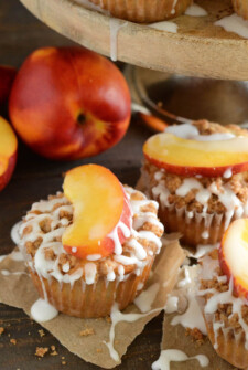 Peaches & Cream Streusel Muffins: tender muffins loaded with fresh peaches and cinnamon are topped with a sweet streusel topping and creamy vanilla icing.