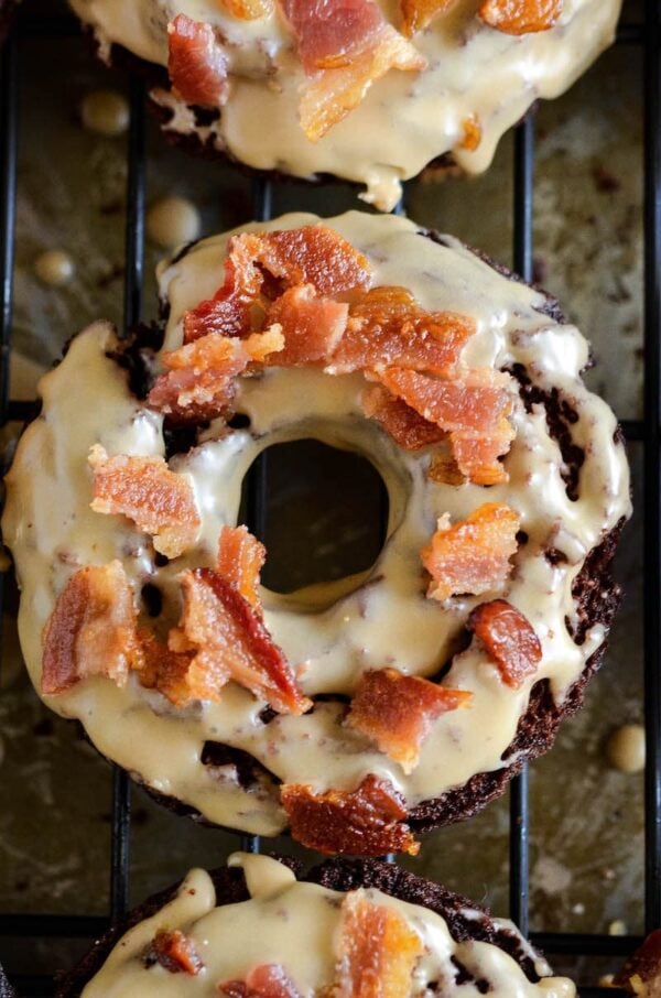 Chocolate Maple Bacon Donuts: old fashioned chocolate donuts, made extra tender with hidden yogurt, are fried and dunked in a maple glaze and topped with bacon!
