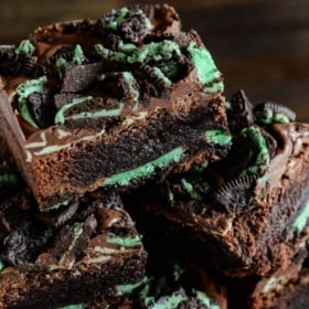 Andes mint brownies with mint oreos baked inside stacked on top of each other.