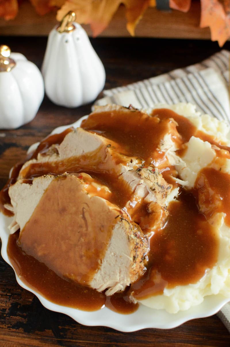 A plate of Instant Pot gravy over turkey and mashed potatoes