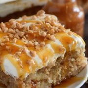 Caramel Apple Toffee Cake: a homemade - from scratch - poke cake is filled with bites of apple, toffee, caramel sauce and topped with sweet whipped cream!