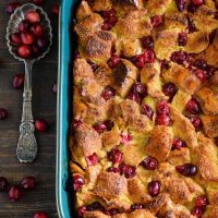 Cranberry Eggnog Bread Pudding: kick off the holidays with this rich bread pudding with cranberries, eggnog, cinnamon and a generous pour of buttery rum sauce!