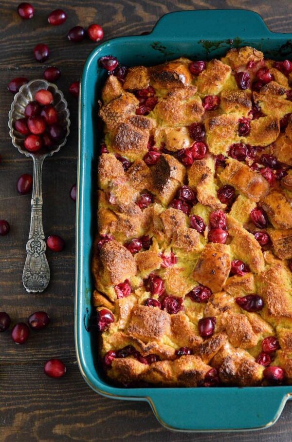 Cranberry Eggnog Bread Pudding: kick off the holidays with this rich bread pudding with cranberries, eggnog, cinnamon and a generous pour of buttery rum sauce!