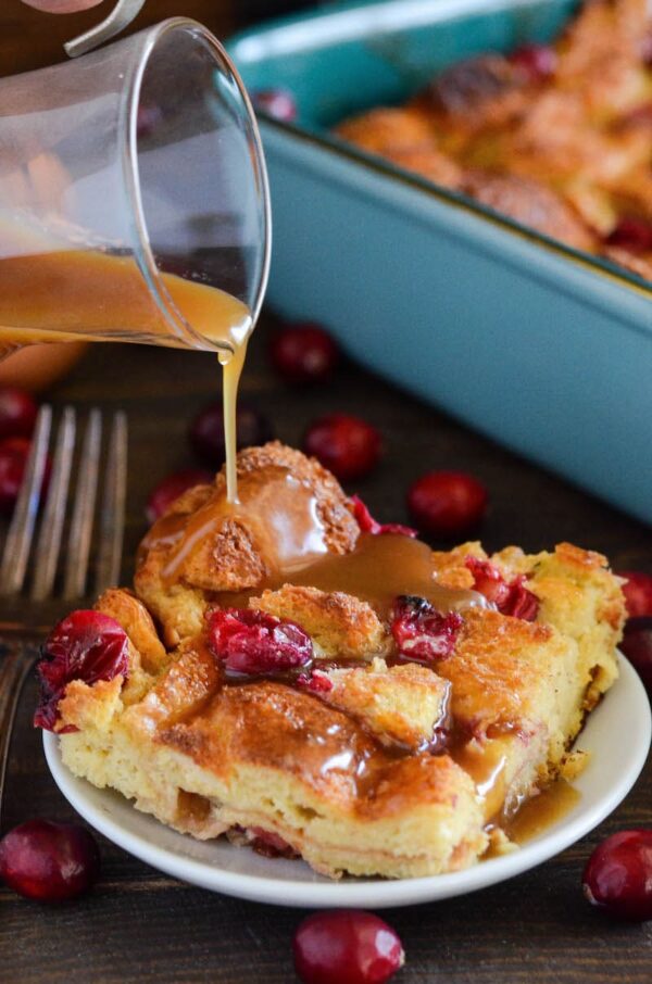 Cranberry Eggnog Bread Pudding: kick off the holidays with this rich bread pudding with cranberries, eggnog, cinnamon and a generous pour of buttery rum sauce!