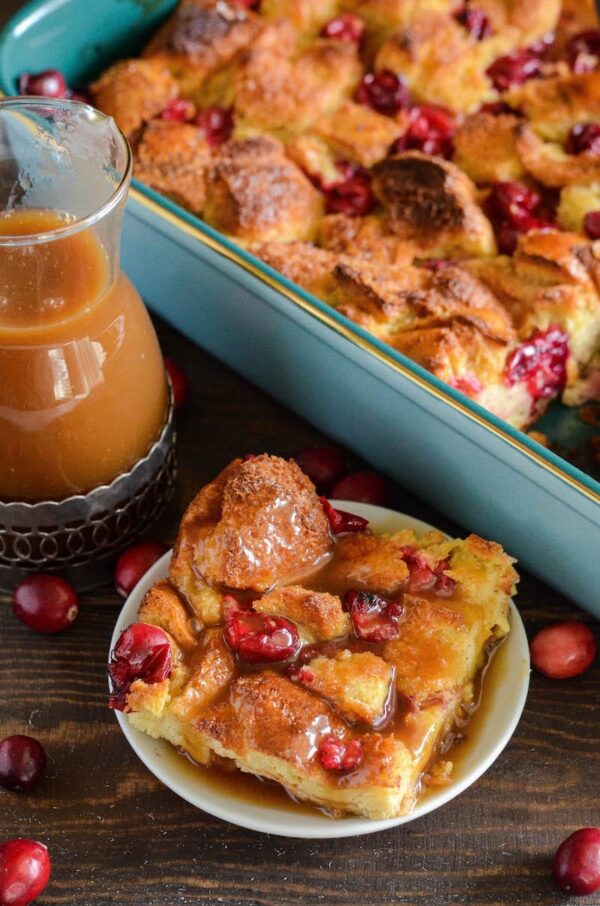 Cranberry Eggnog Bread Pudding: kick off the holidays with this rich bread pudding with cranberries, eggnog, cinnamon and a generous pour of buttery rum sauce!