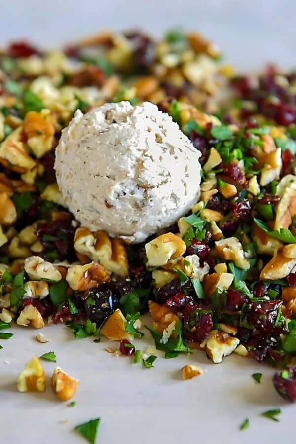 Goat cheese has been added to a mixture of pecans, parsley, and cranberries.