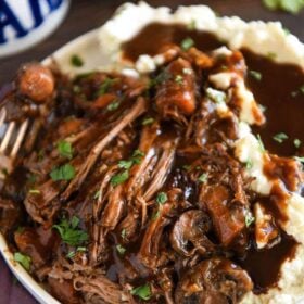 Slow Cooker Beef Pot Roast: a favorite family recipe for an extra flavorful tender beef pot roast that is always an instant favorite! You will never guess the secret ingredients! #SlowCooker #CrockPot #PotRoast