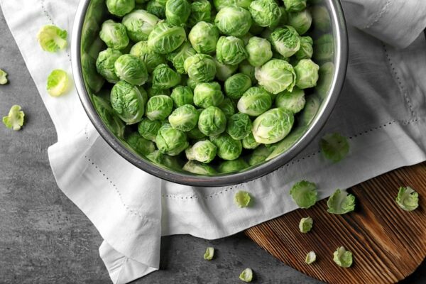 Fresh brussel sprouts in a metal bowl. 