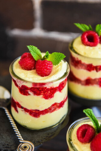 Lemon Raspberry Fluff: sweet whipped cream and zesty lemon curd are whipped together and layered with smashed fresh red raspberries for this delicious dessert!