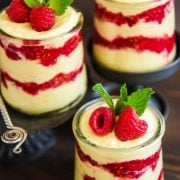 Lemon Raspberry Fluff in three glasses with fresh raspberries and mint on top.