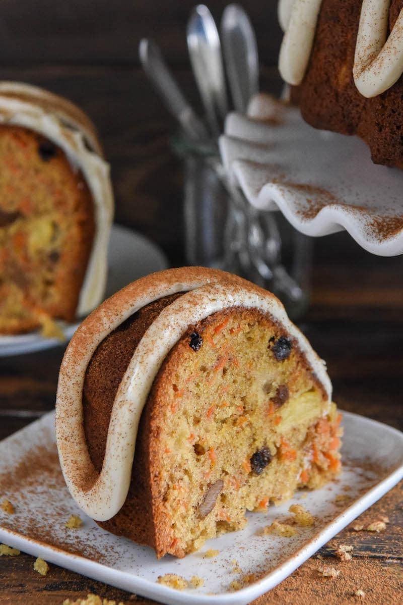 A Slice of Carrot Bundt Cake on a Square, White Plate on a Dining Room Table