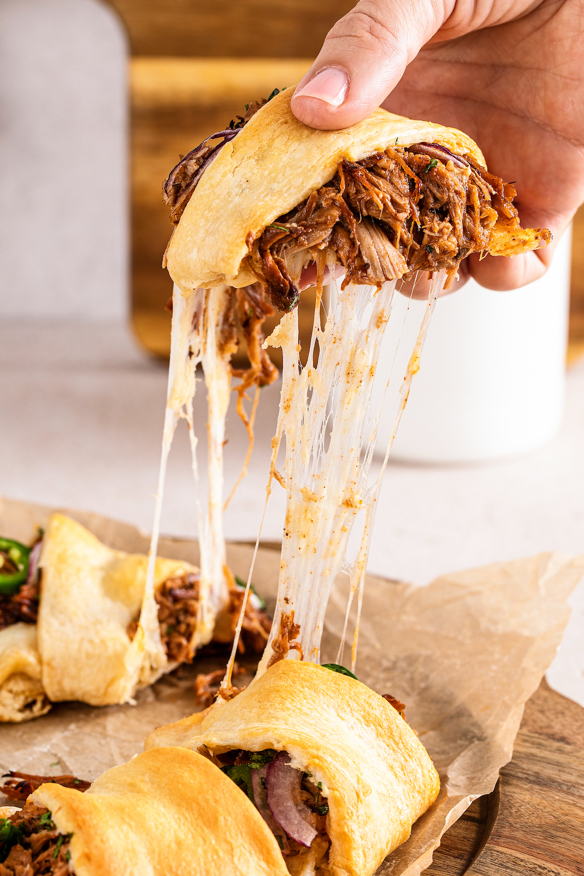 Pulled pork appetizer with a cheese pull.