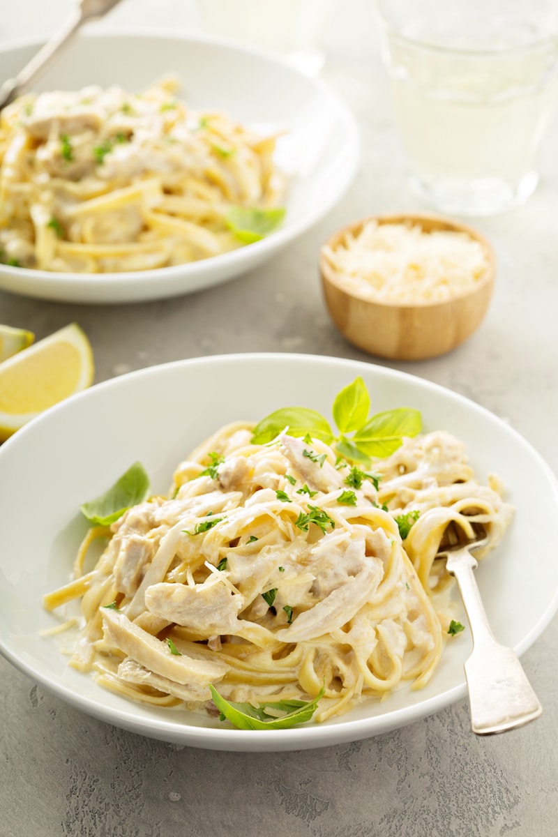 Pasta and chicken in a large, shallow bowl.