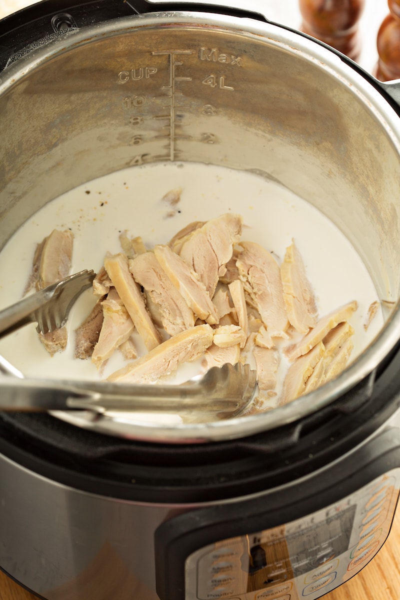 Chicken, cream, and other ingredients in the Instant Pot.