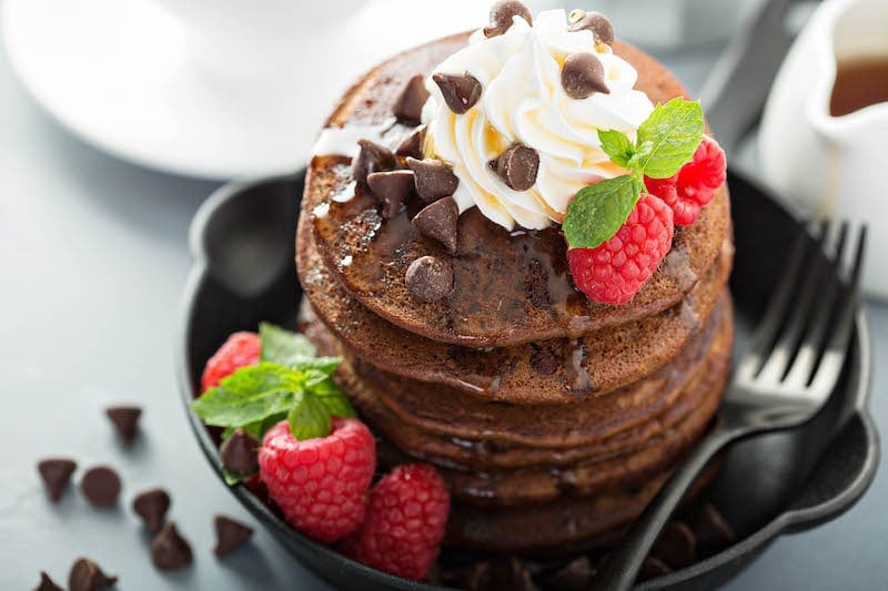 A Stack of Chocolate Chip Pancakes Topped with Chocolate Chips and Fresh Berries