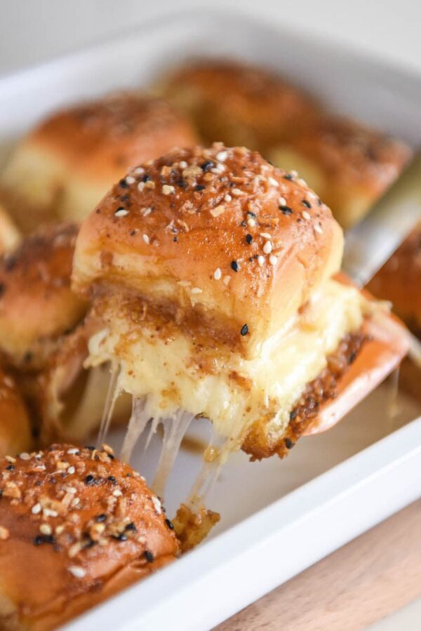 Cheesy Turkey Sliders: these melted turkey and havarti sliders are covered in a buttery sauce and served warm out of the oven for the ultimate game day treat! #turkey #appetizer