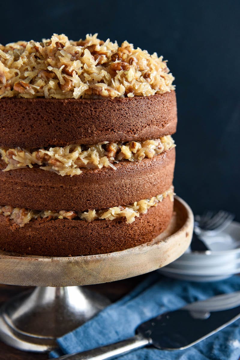 Disney's German Chocolate Cake on a Cake Stand Beside A Dessert Spatula