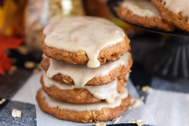 A stack of frosted pumpkin cookies