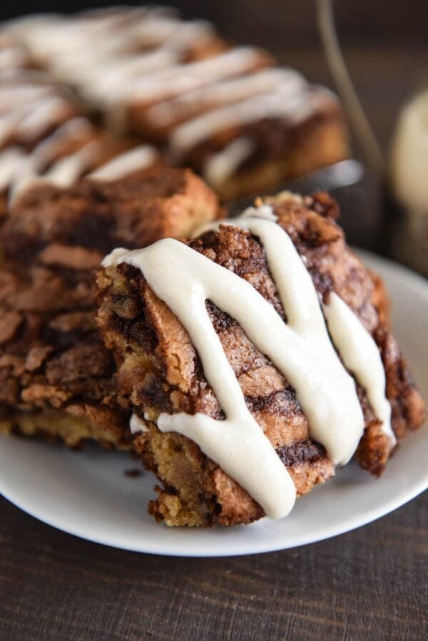 Cinnamon Roll Blondies: super soft blondies are swirled with a sweet cinnamon brown sugar filling and served warm with a drizzle of cream cheese icing! #Blondies #Dessert #CinnamonRoll