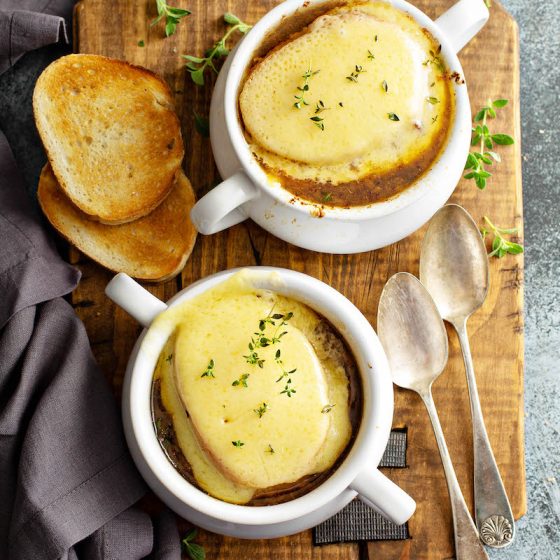 This Crockpot French Onion Soup recipe is loaded with flavor from slow cooking all day with a rich, silky broth and classic broiled cheesy toast topping! #FrenchOnionSoup #Soup #Crockpot #SlowCooker