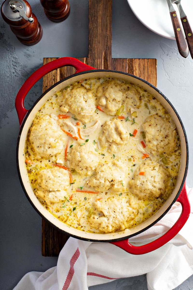 Chicken and Dumplings in a large pot on a chopping board. 
