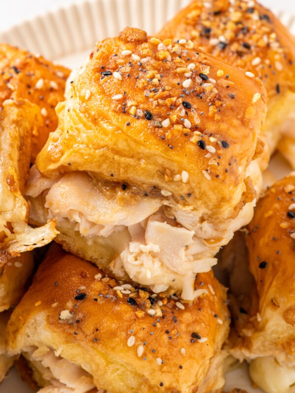 A platter of warm turkey sliders with buttery Dijon topping and everything bagel seasoning.
