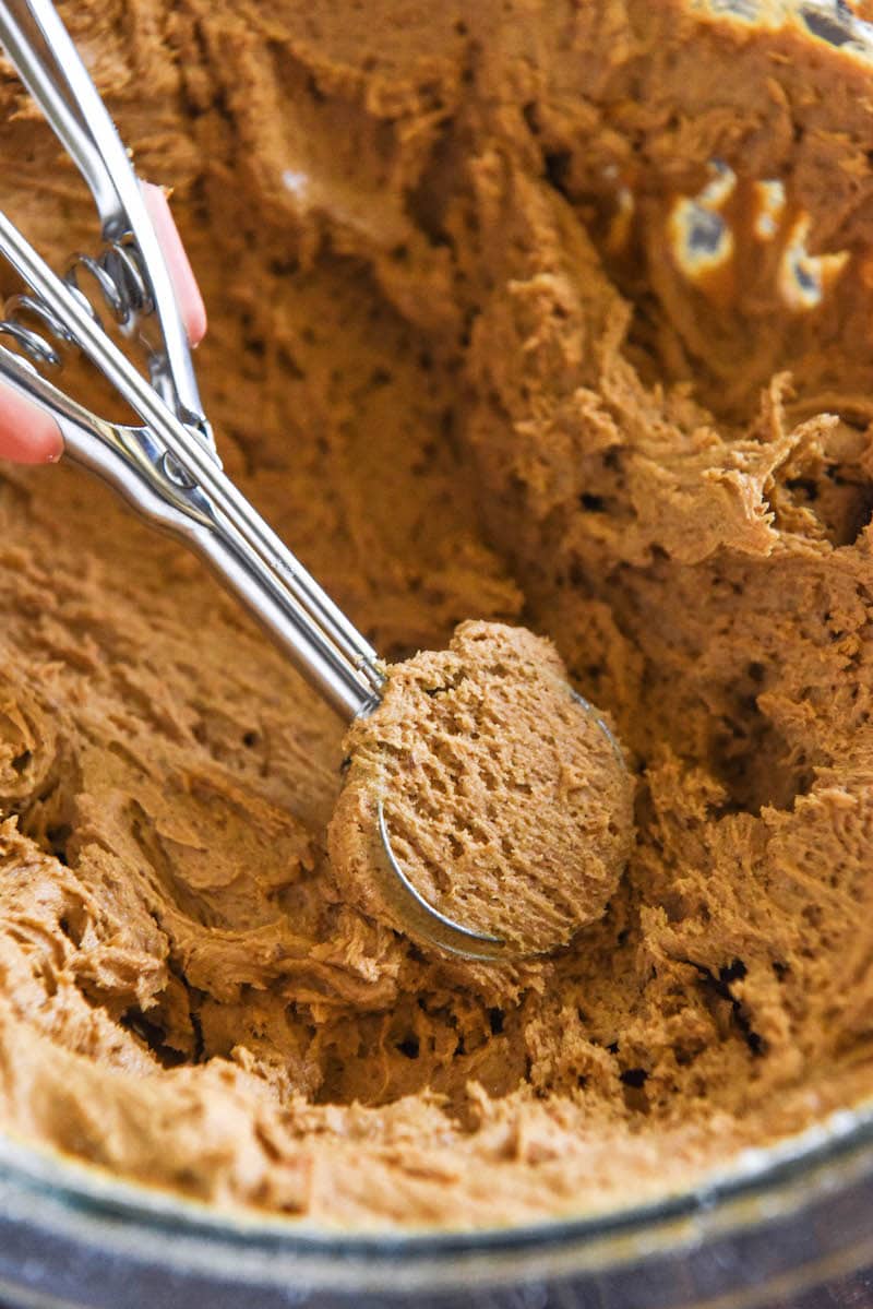 Cookie Dough with a cookie scoop in it.