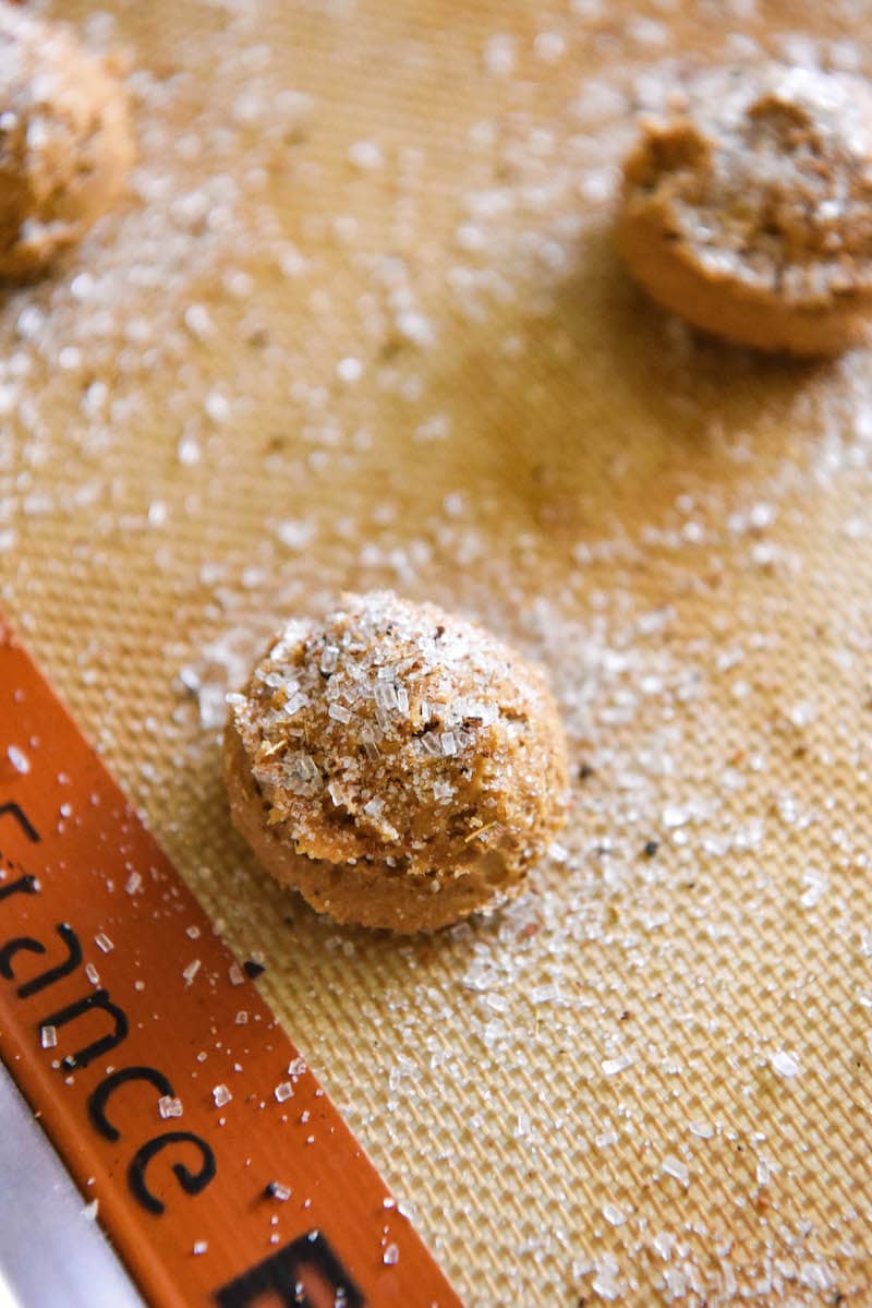 Apple cider cookie dough ball on cookie sheet.