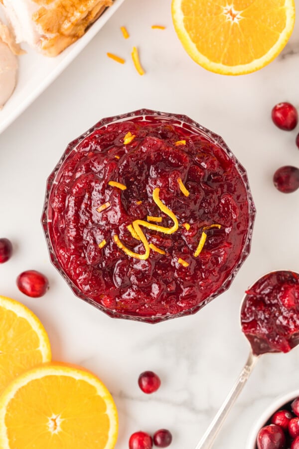 Fresh orange zest is sprinkled across the top of spiced cranberry sauce recipe with orange.