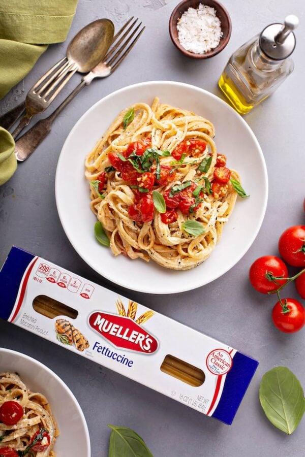 Pasta with Roasted Cherry Tomatoes in a large bowl with ingredients surrounding it