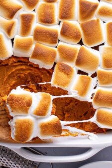 Sweet Potato Casserole with toasted marshmallows and a big spoonful pulled out of it.