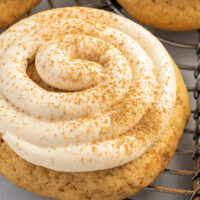 Close-up shot of cookies with piped frosting and a sprinkle of cinnamon.