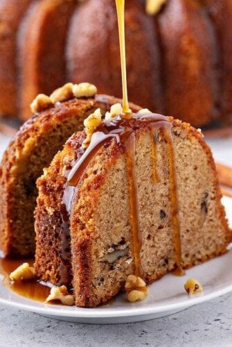 A slice of Walnut Rum Cake drizzled with warm rum sauce.