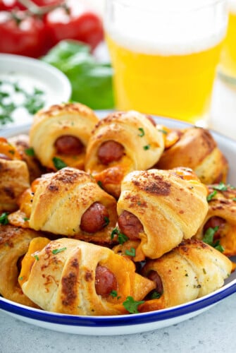 Cheesy Ranch Pigs In A Blanket stacked on top of each other on a plate.