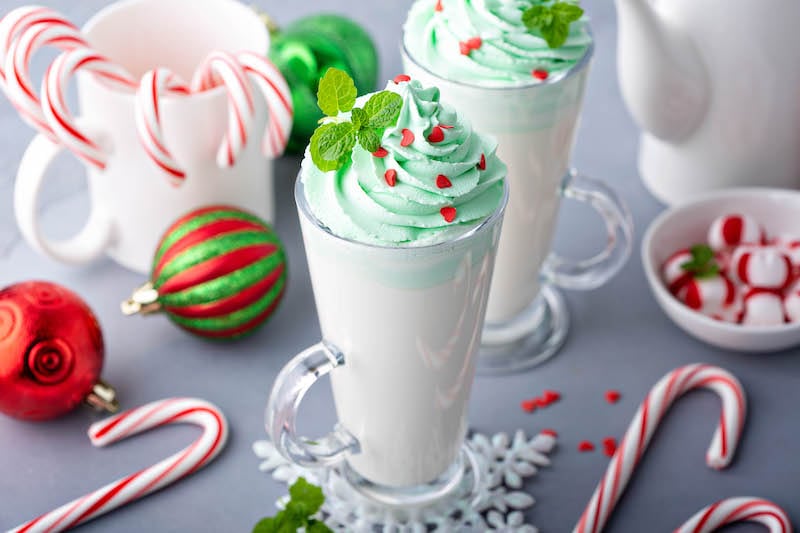 Two Glasses of Peppermint White Hot Chocolate Beside Candy Canes and Ornaments