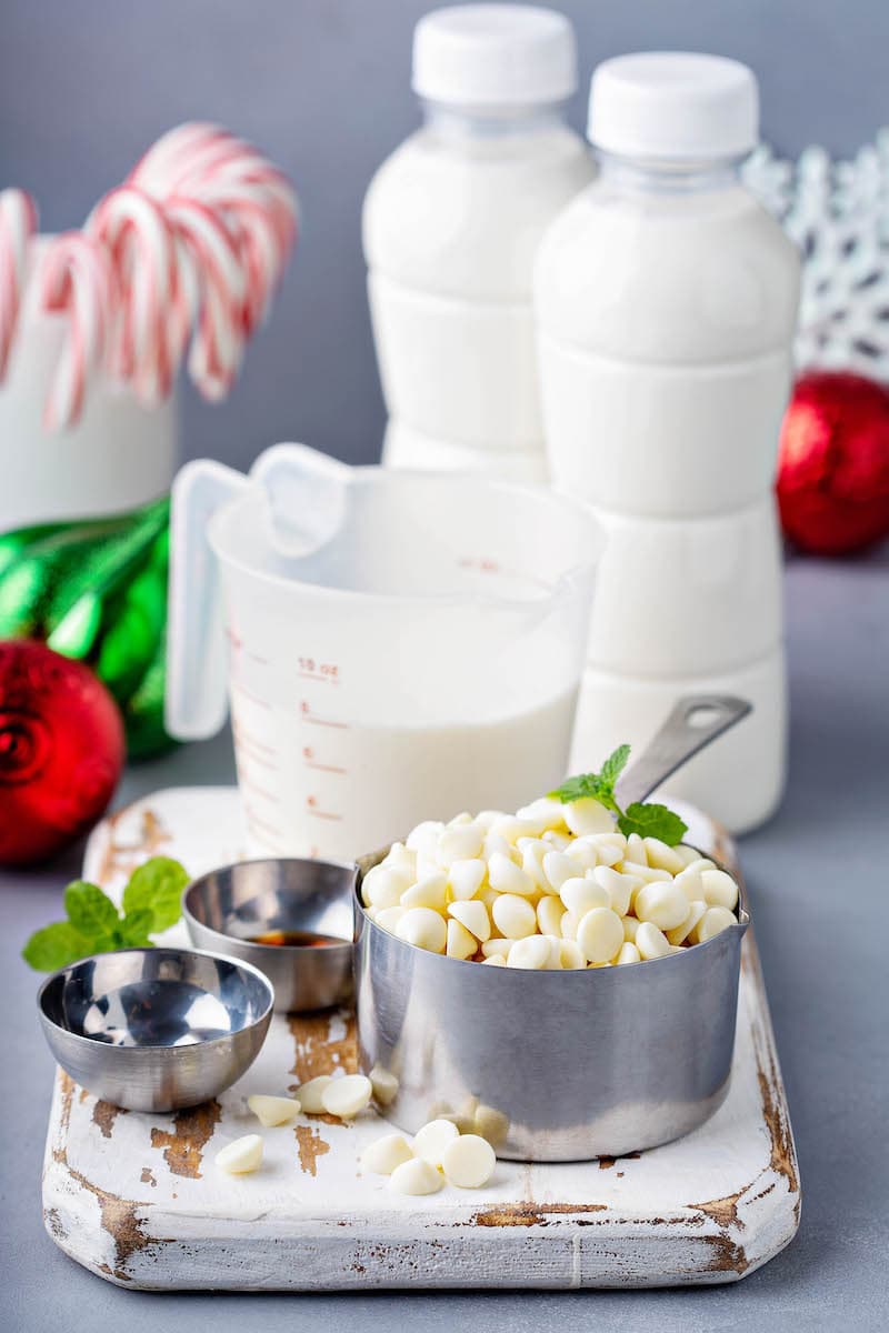 White Chocolate Chips, Half and Half, Vanilla Extract and the Rest of the Christmas Hot Cocoa Ingredients on a Cutting Board